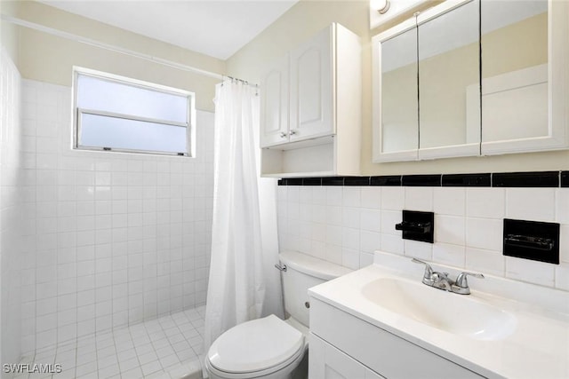 527 Goodland Drive W, Goodland, FL 34140 - bathroom with a tile shower, vanity, and tile walls