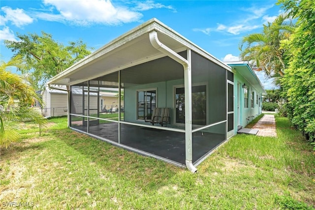 527 Goodland Drive W, Goodland, FL 34140 - back of house with a sunroom and a lawn