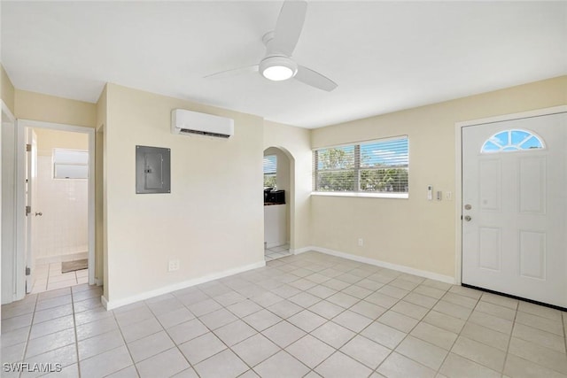 527 Goodland Drive W, Goodland, FL 34140 - foyer featuring a wall mounted AC, electric panel, ceiling fan, arched walkways, and light tile patterned floors