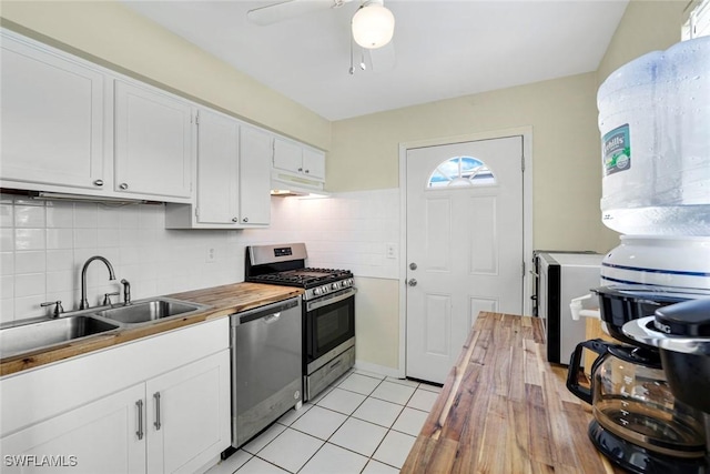 527 Goodland Drive W, Goodland, FL 34140 - kitchen featuring stainless steel appliances, butcher block counters, under cabinet range hood, and white cabinetry