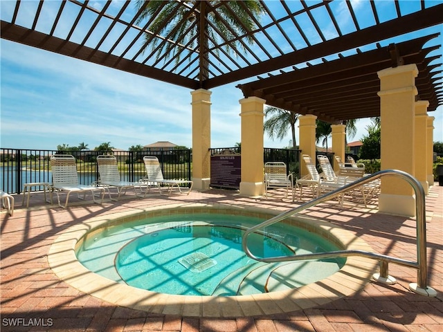 1381 Areca Cv, Naples, FL 34119 - view of pool with a hot tub, a patio, a water view, and a pool