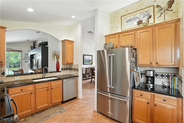 1381 Areca Cv, Naples, FL 34119 - kitchen featuring stainless steel appliances, arched walkways, decorative backsplash, dark stone counters, and recessed lighting