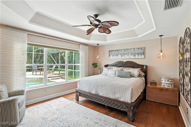 1381 Areca Cv, Naples, FL 34119 - bedroom with a raised ceiling, wood finished floors, and ceiling fan