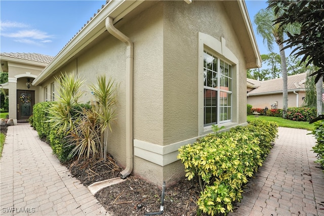 1381 Areca Cv, Naples, FL 34119 - view of side of property with stucco siding
