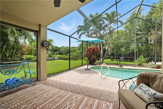 1381 Areca Cv, Naples, FL 34119 - outdoor pool featuring a patio area, glass enclosure, a yard, view of wooded area, and a water view