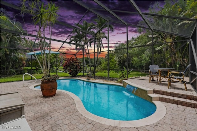 1381 Areca Cv, Naples, FL 34119 - pool at dusk featuring a patio area, a lanai, and an outdoor pool