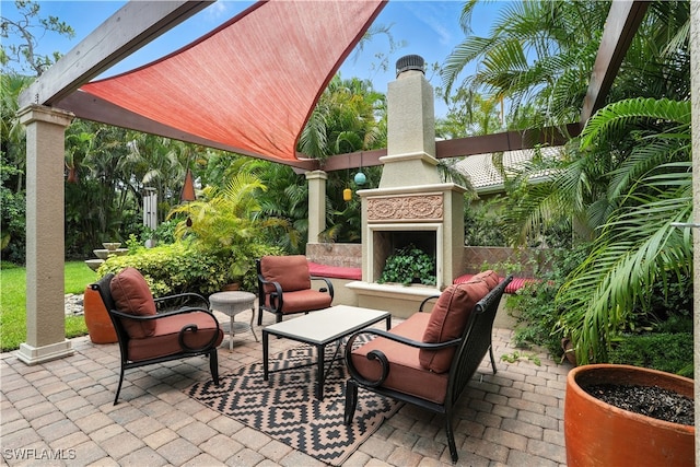 1381 Areca Cv, Naples, FL 34119 - view of patio featuring exterior fireplace