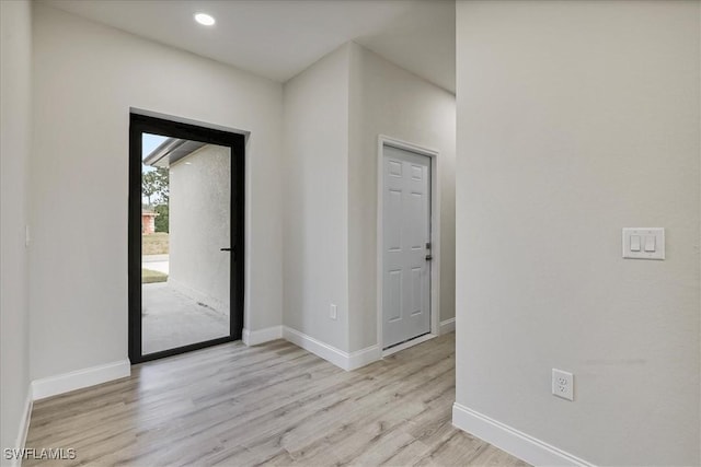 foyer entrance with wood finished floors and recessed lighting