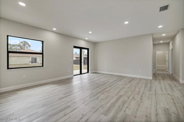 spare room featuring light wood-type flooring and recessed lighting