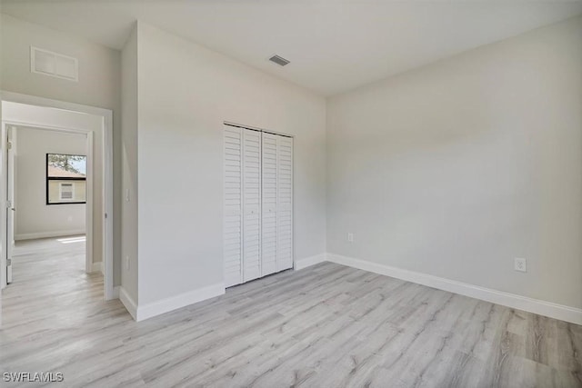 unfurnished bedroom featuring light wood finished floors and baseboards