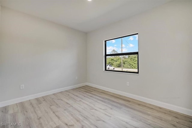 spare room with wood finished floors and recessed lighting