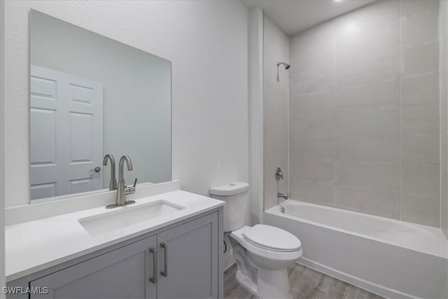 full bathroom featuring wood finished floors, vanity, and bathing tub / shower combination