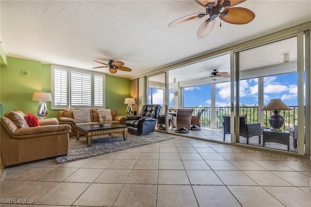4745 Estero Blvd Unit 302, Fort Myers Beach, FL 33931 - living area featuring tile patterned flooring, ceiling fan, and floor to ceiling windows