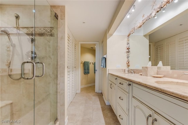 4745 Estero Blvd Unit 302, Fort Myers Beach, FL 33931 - bathroom with double vanity, a closet, a stall shower, and tile patterned floors