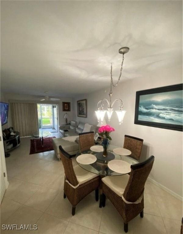850 Elkhorn Ct Unit 213, Marco Island, FL 34145 - dining room featuring a chandelier and light tile patterned flooring