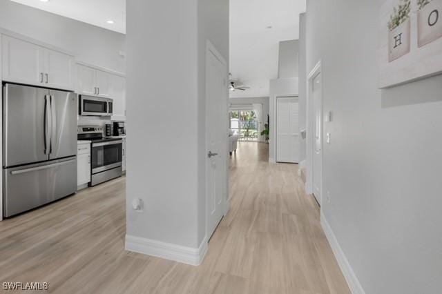 3505 Avion Woods Ct Unit 902, Naples, FL 34104 - hall with light wood finished floors and baseboards