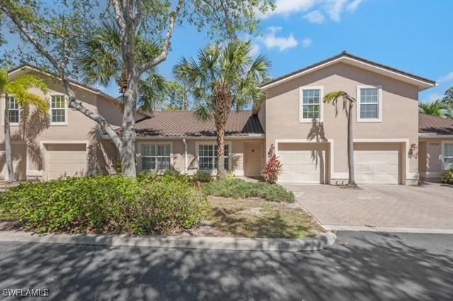 3505 Avion Woods Ct Unit 902, Naples, FL 34104 - traditional home with a garage, stucco siding, and decorative driveway