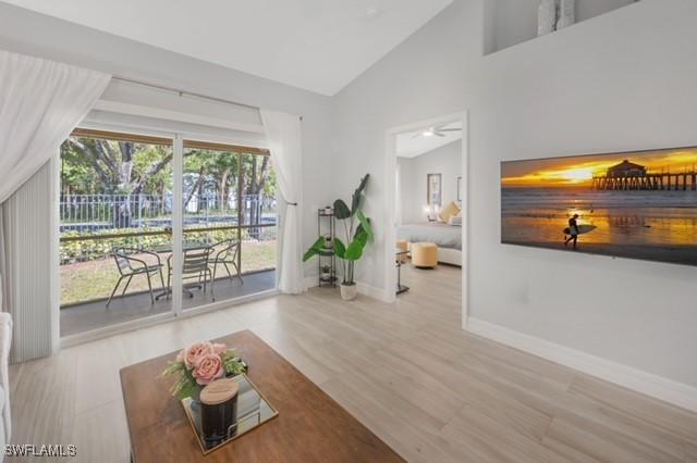 3505 Avion Woods Ct Unit 902, Naples, FL 34104 - living room with lofted ceiling and wood finished floors