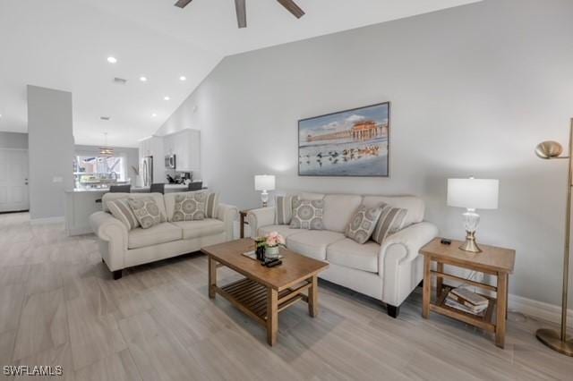 3505 Avion Woods Ct Unit 902, Naples, FL 34104 - living room featuring a ceiling fan, vaulted ceiling, and light wood-type flooring