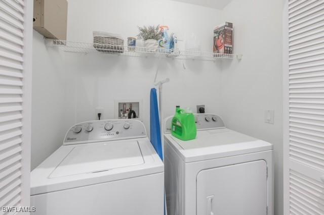 3505 Avion Woods Ct Unit 902, Naples, FL 34104 - laundry area with washer and dryer