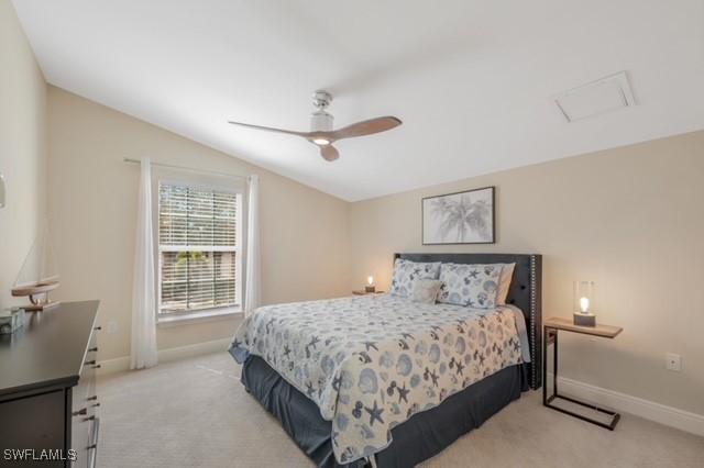 3505 Avion Woods Ct Unit 902, Naples, FL 34104 - bedroom with light colored carpet, lofted ceiling, and ceiling fan