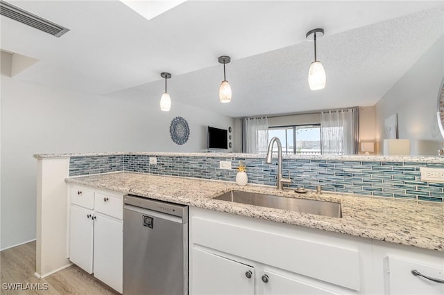 400 Lenell Rd Unit 207, Fort Myers Beach, FL 33931 - kitchen featuring dishwasher, tasteful backsplash, light wood-type flooring, white cabinetry, and pendant lighting