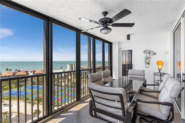 4745 Estero Blvd Unit 1002, Fort Myers Beach, FL 33931 - sunroom / solarium featuring a water view, a textured ceiling, and a wall of windows