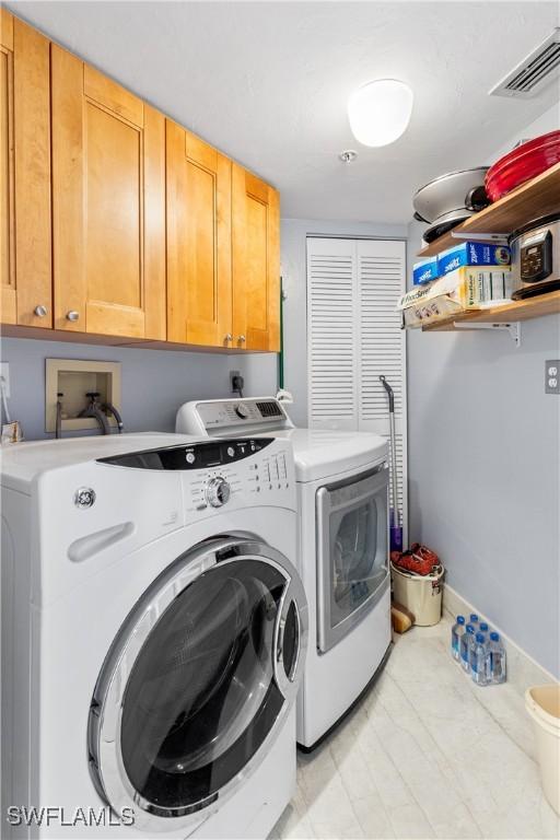 4745 Estero Blvd Unit 1002, Fort Myers Beach, FL 33931 - washroom with cabinet space and washing machine and dryer