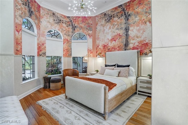 12850 Terabella Way, Fort Myers, FL 33912 - bedroom featuring a chandelier, wood finished floors, crown molding, and a high ceiling