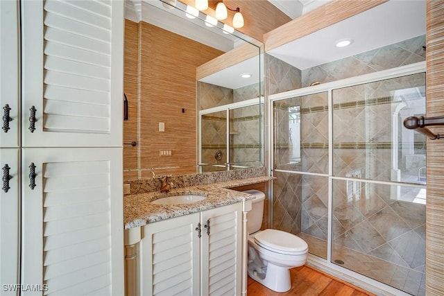 12850 Terabella Way, Fort Myers, FL 33912 - full bathroom with vanity, a shower stall, wood finished floors, and tile walls