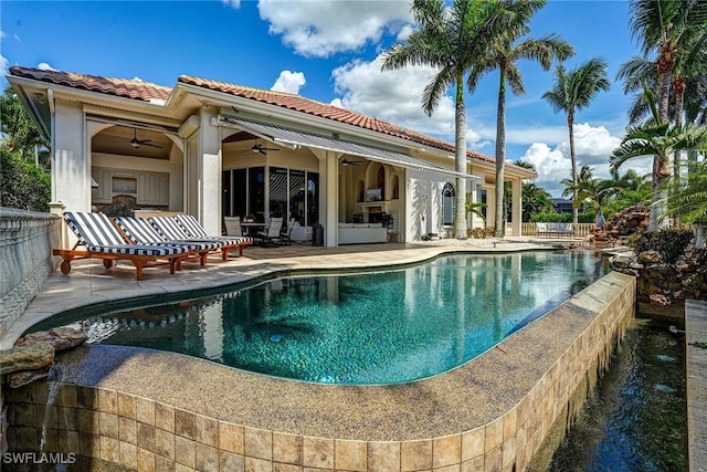 12850 Terabella Way, Fort Myers, FL 33912 - back of house featuring a ceiling fan, a patio, a tiled roof, an outdoor pool, and an outdoor hangout area