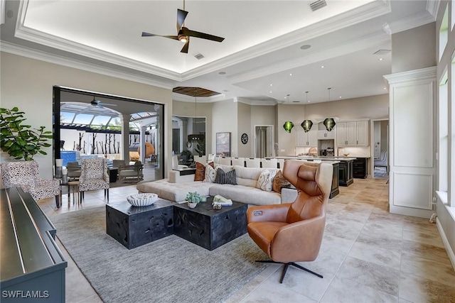 12850 Terabella Way, Fort Myers, FL 33912 - living area with ceiling fan, ornamental molding, a raised ceiling, light tile patterned floors, and recessed lighting