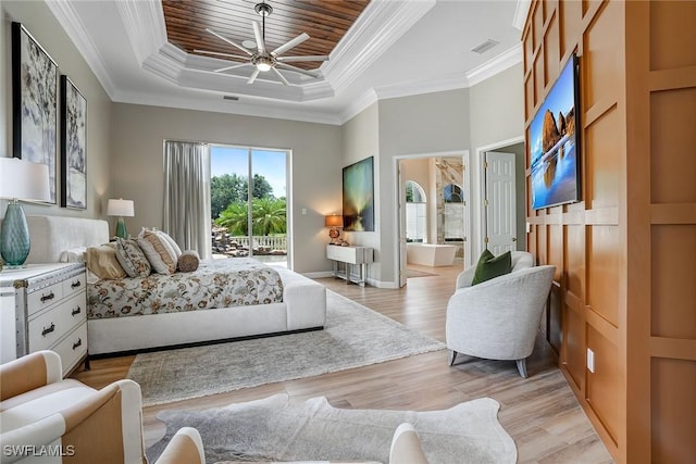 12850 Terabella Way, Fort Myers, FL 33912 - bedroom with a tray ceiling, access to outside, light wood-style flooring, crown molding, and a ceiling fan