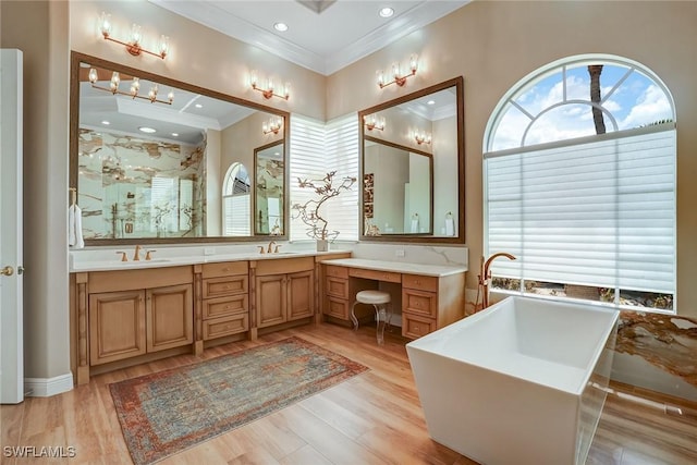 12850 Terabella Way, Fort Myers, FL 33912 - bathroom with ornamental molding, a freestanding bath, double vanity, a stall shower, and wood finished floors