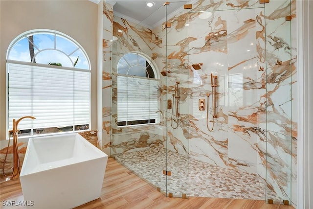 12850 Terabella Way, Fort Myers, FL 33912 - full bath with ornamental molding, a marble finish shower, wood finished floors, and a freestanding tub