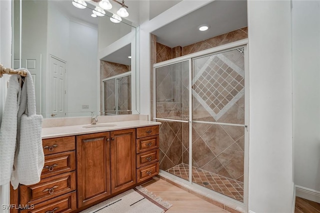 12850 Terabella Way, Fort Myers, FL 33912 - full bathroom with vanity, a stall shower, and wood finished floors
