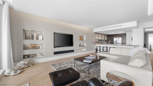 300 Dunes Blvd Unit 404, Naples, FL 34110 - living room featuring wood finished floors and baseboards
