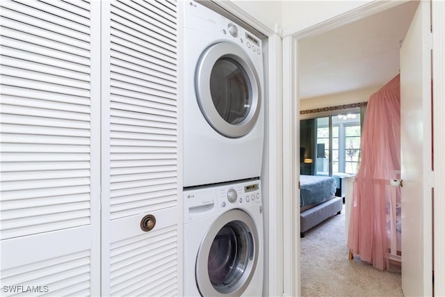 1014 Pine Isle Ln Unit 1014, Naples, FL 34112 - laundry room with stacked washer and clothes dryer and carpet floors