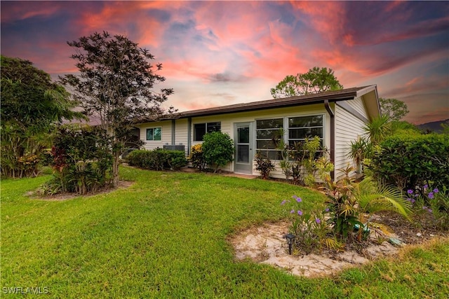 1014 Pine Isle Ln Unit 1014, Naples, FL 34112 - back of property featuring a lawn