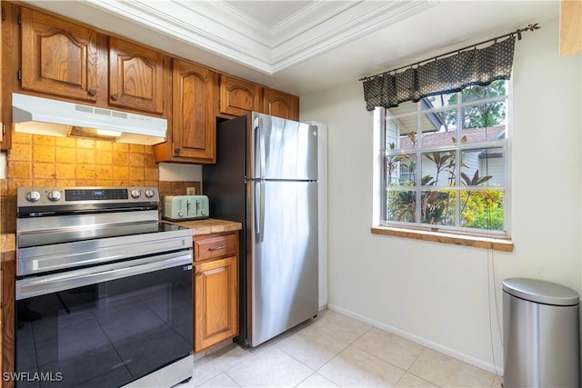 1014 Pine Isle Ln Unit 1014, Naples, FL 34112 - kitchen with appliances with stainless steel finishes, under cabinet range hood, backsplash, ornamental molding, and brown cabinets