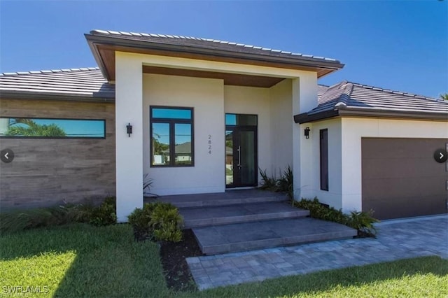 4612 SW 22nd Pl, Cape Coral, FL 33914 - entrance to property featuring a tile roof, stucco siding, and a garage