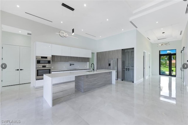4612 SW 22nd Pl, Cape Coral, FL 33914 - kitchen featuring modern cabinets, stainless steel appliances, a towering ceiling, white cabinets, and light countertops