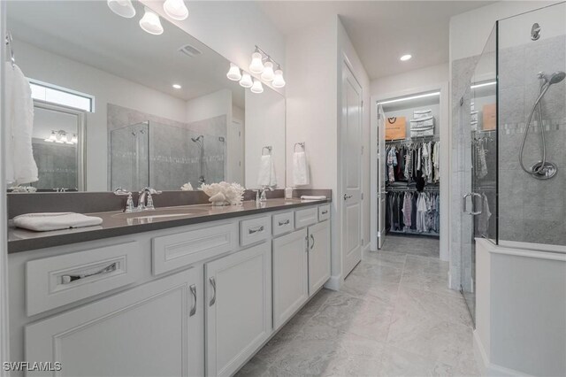 19855 Beverly Park Rd, Estero, FL 33928 - bathroom featuring a stall shower, double vanity, a spacious closet, marble finish flooring, and recessed lighting