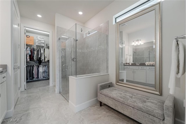 19855 Beverly Park Rd, Estero, FL 33928 - bathroom with vanity, a stall shower, a walk in closet, and recessed lighting