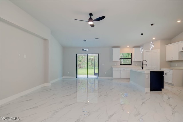 3606 51st St W, Lehigh Acres, FL 33971 - kitchen with ceiling fan, light countertops, a kitchen island with sink, open floor plan, and white cabinets