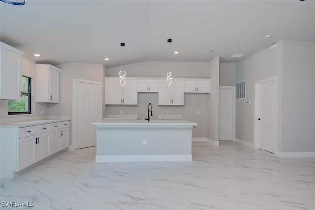 3606 51st St W, Lehigh Acres, FL 33971 - kitchen with light marble finish flooring, a kitchen island with sink, white cabinetry, recessed lighting, and pendant lighting