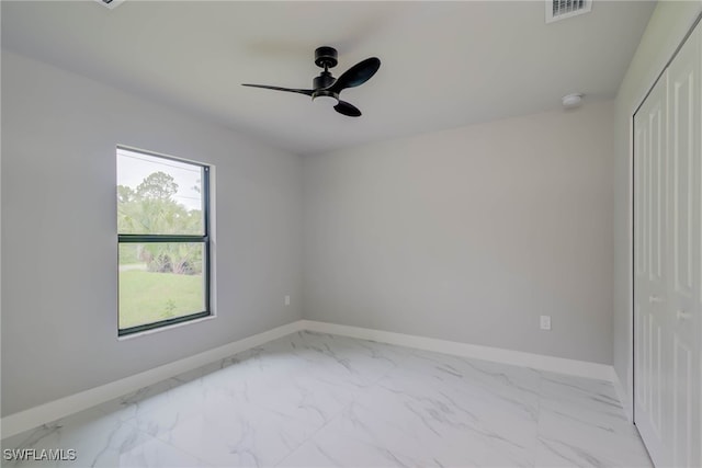 3606 51st St W, Lehigh Acres, FL 33971 - spare room with a ceiling fan and marble finish flooring