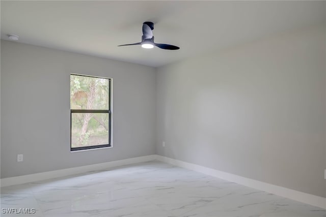 3606 51st St W, Lehigh Acres, FL 33971 - empty room featuring light marble finish flooring, a smoke detector, and a ceiling fan