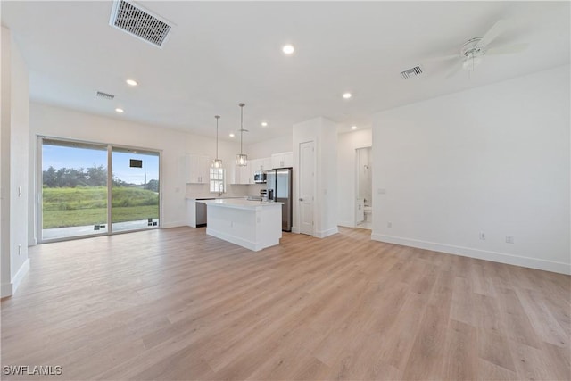3111 11th St W, Lehigh Acres, FL 33971 - unfurnished living room featuring ceiling fan, light wood-style flooring, and recessed lighting