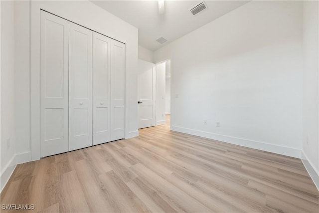 3109 11th St W, Lehigh Acres, FL 33971 - unfurnished bedroom featuring light wood-style flooring and a closet